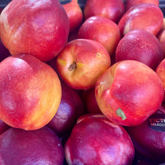 Rich red and orange colours of ripe nectarines at a fruit market in Spain